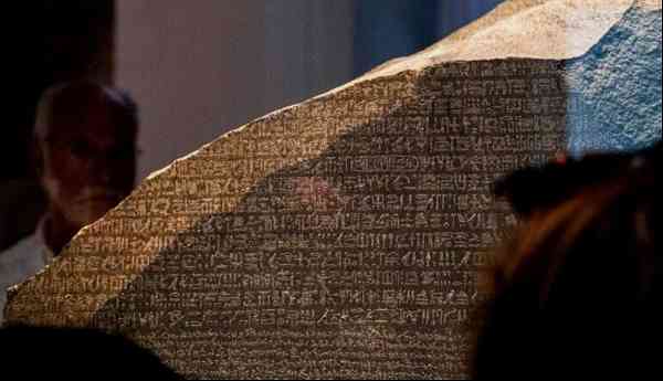 Visitors view the Rosetta Stone at the British Museum.